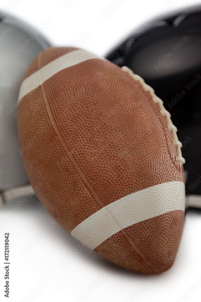 Close up of American football by sports helmet Close up of American football by sports helmet
