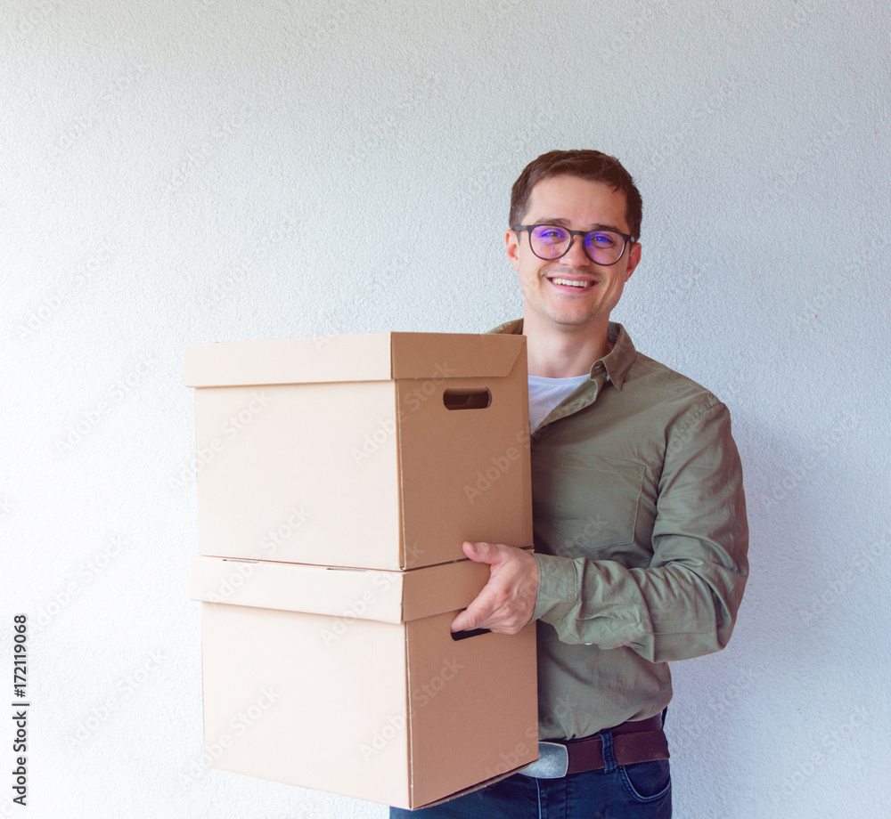 Handsome man with moving boxes on white background Handsome man with moving boxes on white background