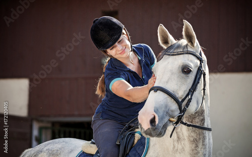 Horse rider woman near stable horsewoman before training