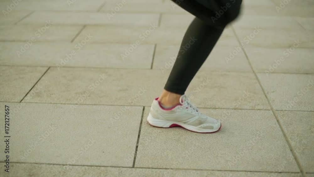 Female feet jump over the rope. Fitness, sports, outdoor activities. Female feet jump over the rope. Fitness, sports, outdoor activities.