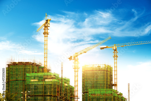 Lots of tower Construction site with cranes and building with blue sky background photo