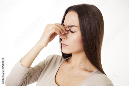 A terrible headache in a woman is isolated on white.