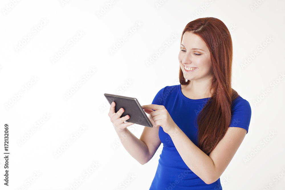 Smiling Woman uses digital tablet with copy space. Smiling Woman uses digital tablet with copy space.