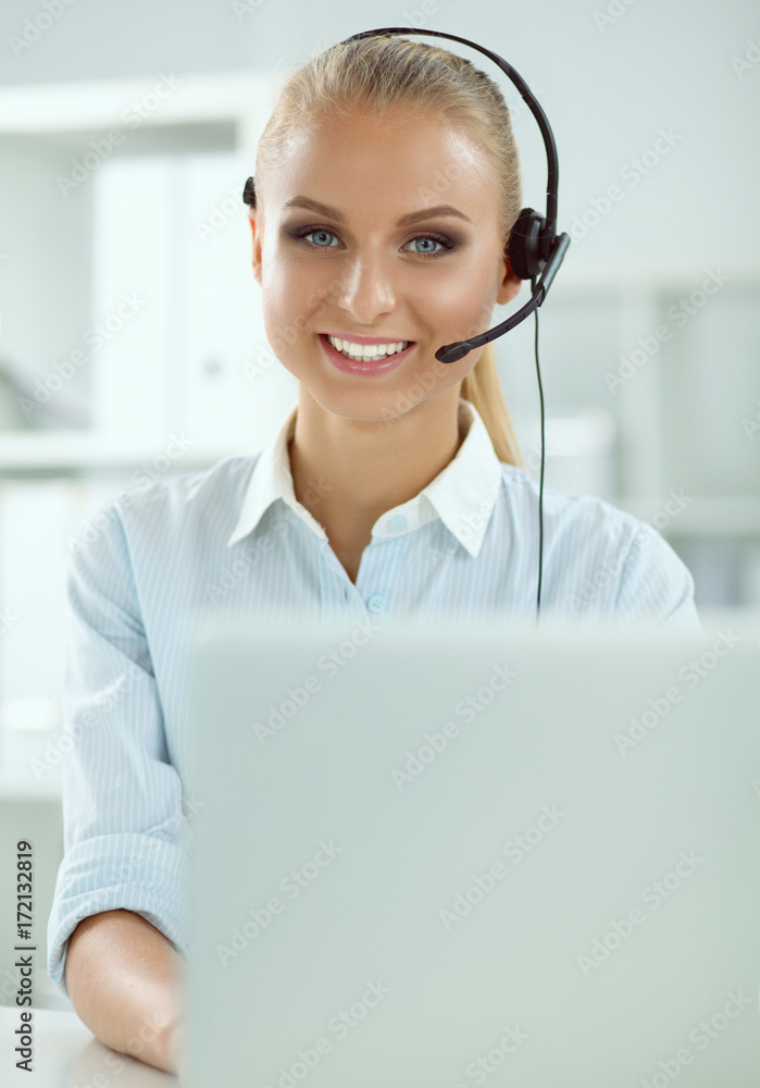 Close-up portrait of a customer service agent sitting at office Close-up portrait of a customer service agent sitting at office