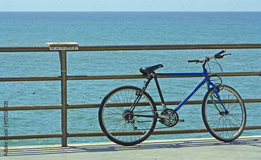 Fototapeta premium Bikcyle parked on a pier over the ocean