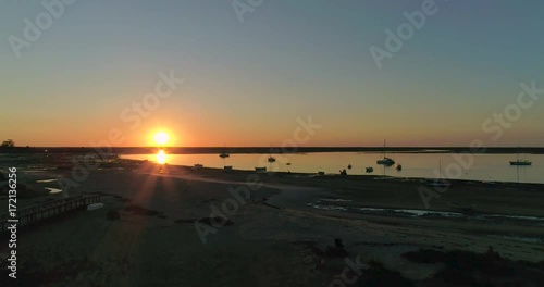 Sunrise aerial seascape, in Ria Formosa wetlands natural park, shot over Cavacos beach. Algarve.