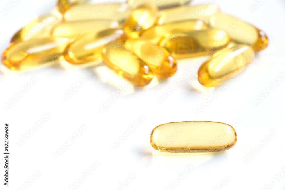 Yellow color soft gelatin capsule on white background (Concept of medicine, drug, nutrition supplement) Yellow color soft gelatin capsule on white background (Concept of medicine, drug, nutrition supplement)