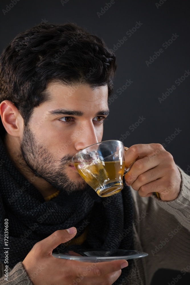 Thoughtful man having a cup of lemon tea Thoughtful man having a cup of lemon tea