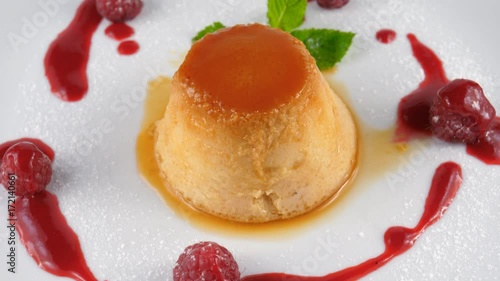 Caramel pudding with caramel sauce and raspberries, loop, 4K, ProRes codec, 422 HQ, ISO 100