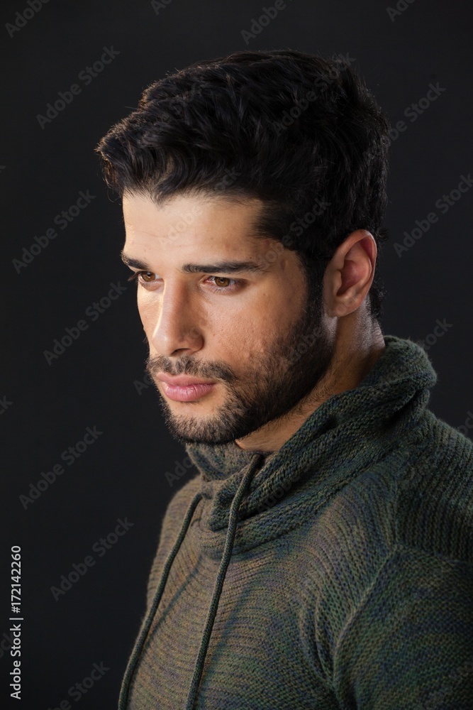 Man standing against black background