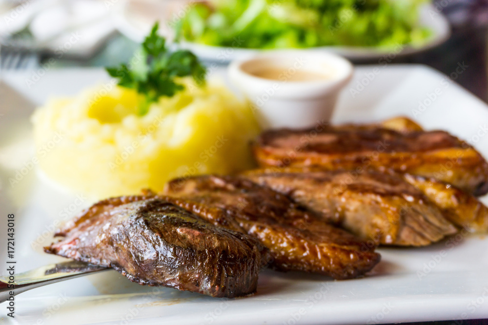 juicy steak beef meat with tomato and potatoes juicy steak beef meat with tomato and potatoes