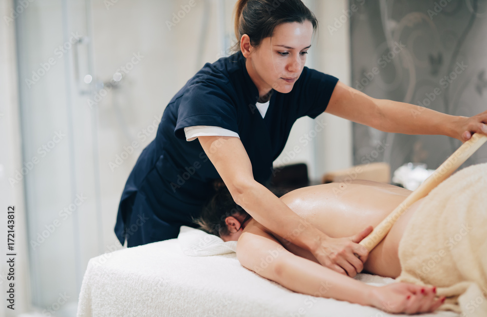 Masseur massaging masseuse at wellness resort Masseur massaging masseuse at wellness resort