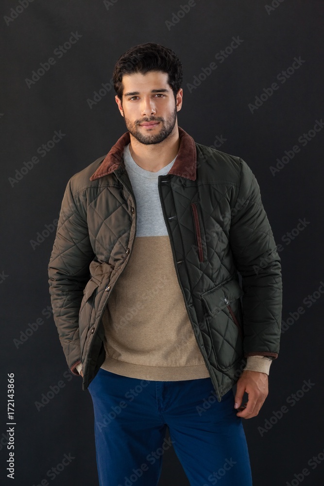 Man posing against black background