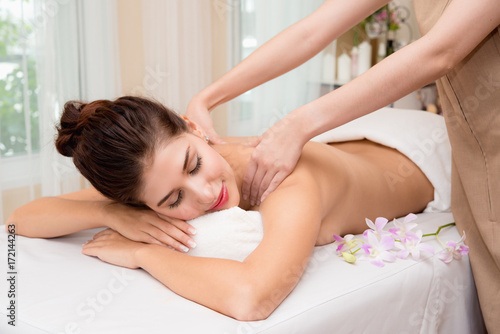 Masseur doing massage on woman body in the spa salon. Beauty treatment concept