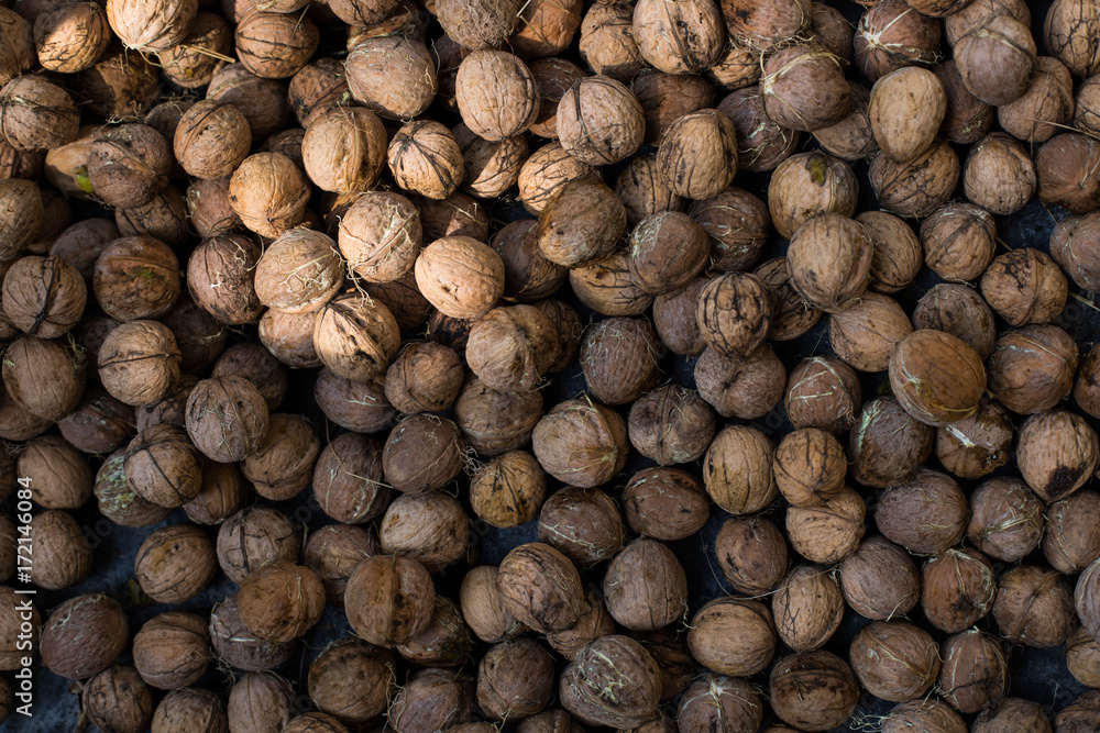 Many greek walnuts. Greek Nuts in a box. Texture nuts background Many greek walnuts. Greek Nuts in a box. Texture nuts background