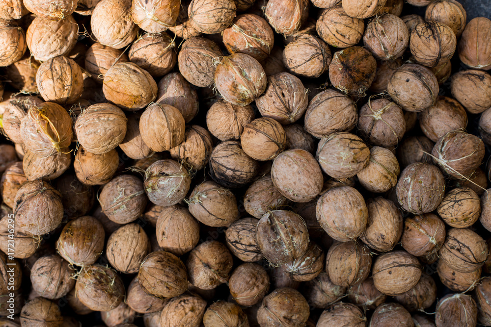 Many greek walnuts. Greek Nuts in a box. Texture nuts background Many greek walnuts. Greek Nuts in a box. Texture nuts background