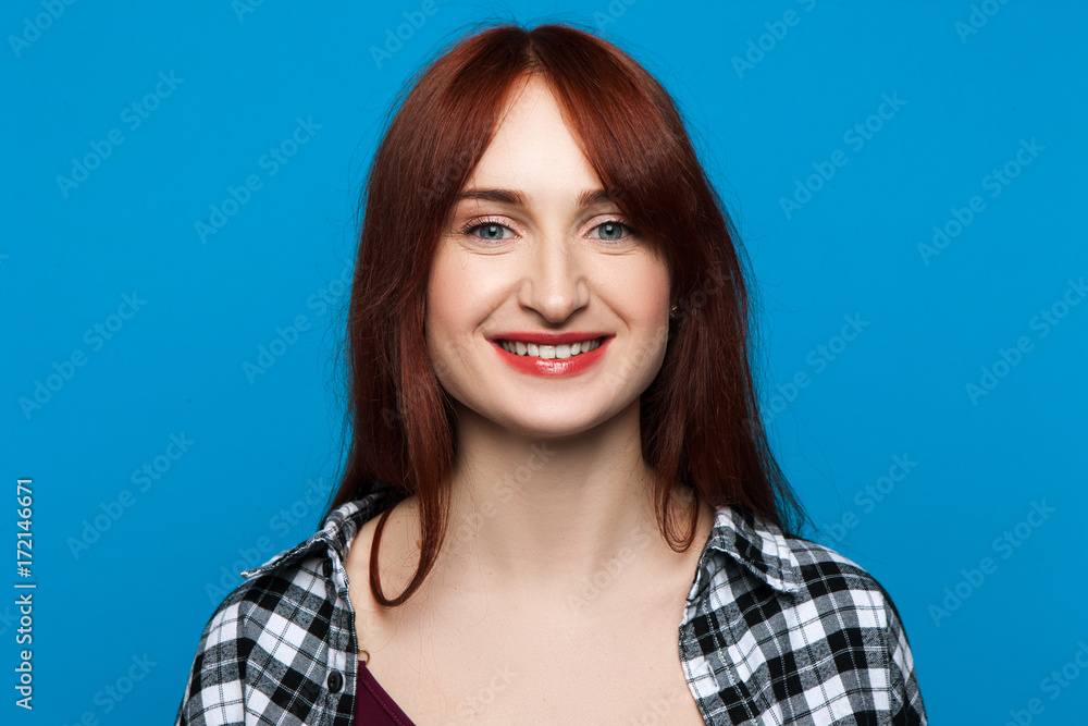 Joyful young female openly smiling on pop blue backdrop. Happiness background. Good news for pretty woman, lively face, fortune concept Joyful young female openly smiling on pop blue backdrop. Happiness background. Good news for pretty woman, lively face, fortune concept