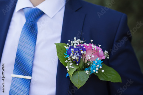 boutonniere in the blue jacket of the groom