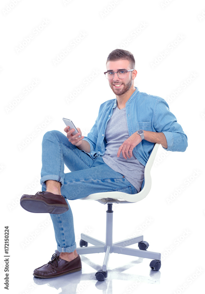 Young man sitting on chair and using mobile phone. Startupper. Young entrepreneur.