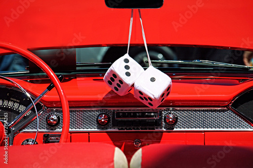 Detail of classic car with fuzzy dice hanging on the mirror