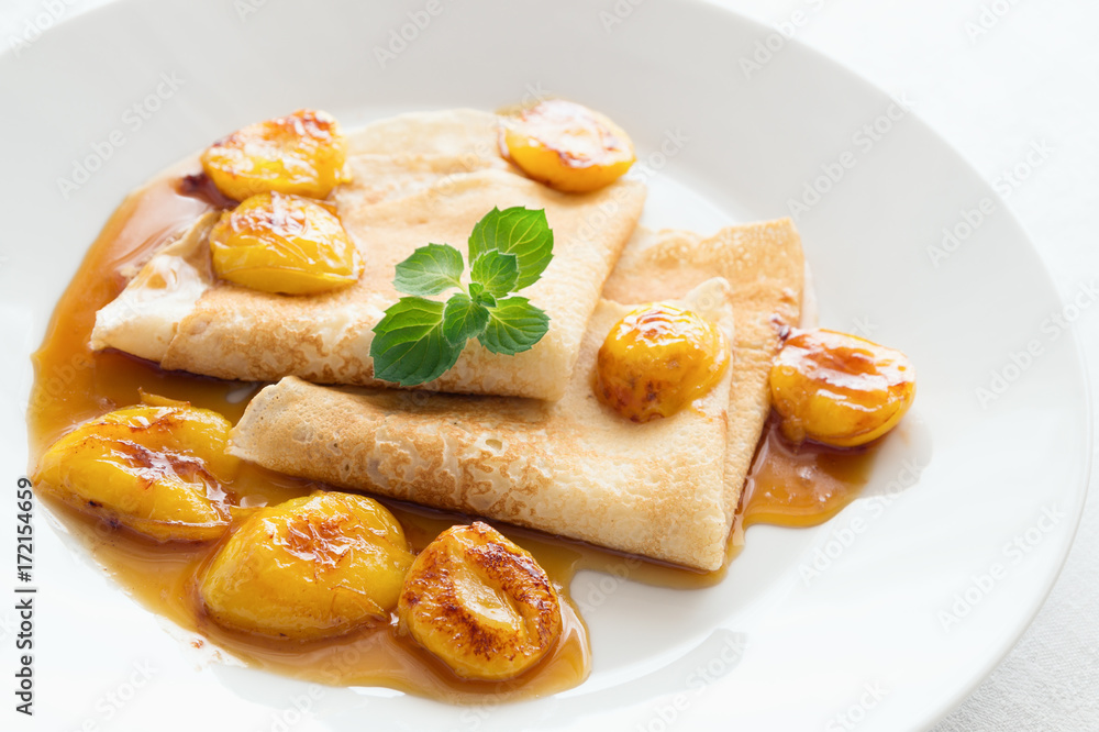 pancakes with honey and plums decorated with mint pancakes with honey and plums decorated with mint