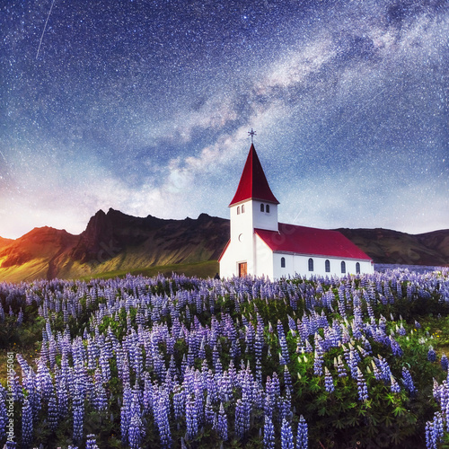 Beautiful collage Lutheran Church in Vik under fantastic starry sky. Iceland © standret