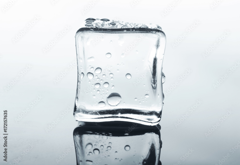 Transparent ice cube with reflection on white Transparent ice cube with reflection on white