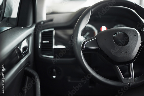 Luxury car Interior - steering wheel, shift lever, dashboard and computer. © standret