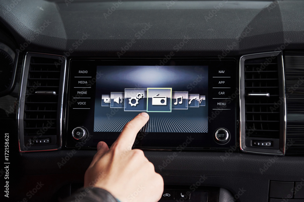 Smart car and internet of things IOT concept. Finger point to car 's console and icons popup out of screen Smart car and internet of things IOT concept. Finger point to car 's console and icons popup out of screen