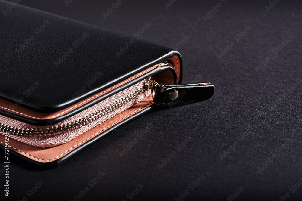 black wallet, isolated on a black background. black wallet, isolated on a black background.