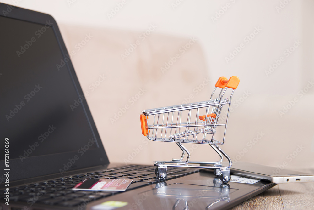miniature shopping cart on laptop