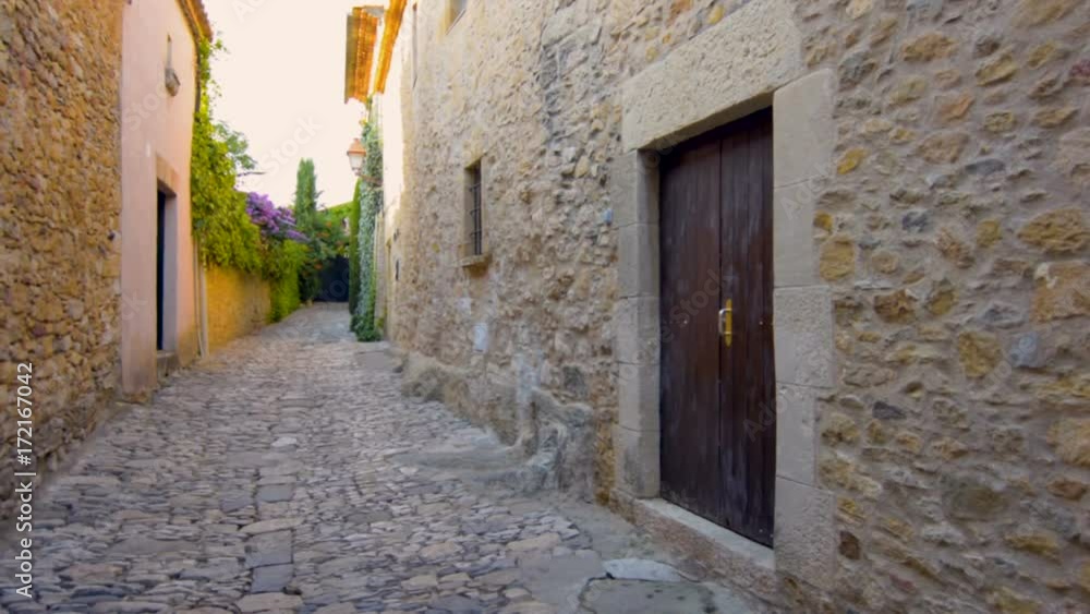 Narrow street in Peratallada. Peratallada is a picturesque medieval old town in the heart of Costa Brava, Catalonia, Spain. Narrow street in Peratallada. Peratallada is a picturesque medieval old town in the heart of Costa Brava, Catalonia, Spain.