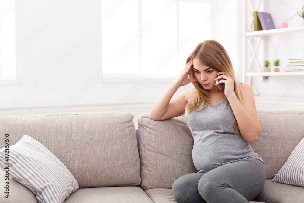 Worried pregnant woman talking on phone Worried pregnant woman talking on phone