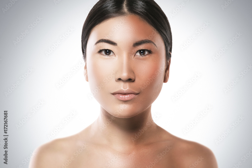 Difference in skin brightness. Concept of facial whitening or sun protection. Difference in skin brightness. Concept of facial whitening or sun protection.