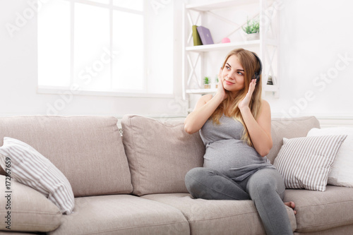 Pregnant woman listening to music in headphones