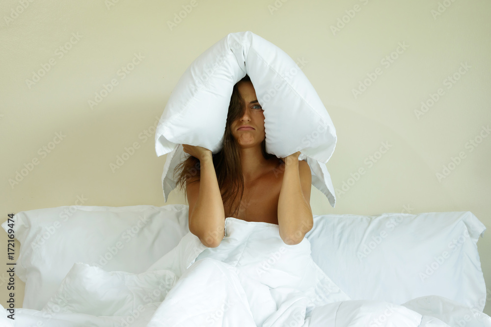 Woman with pillow on her head