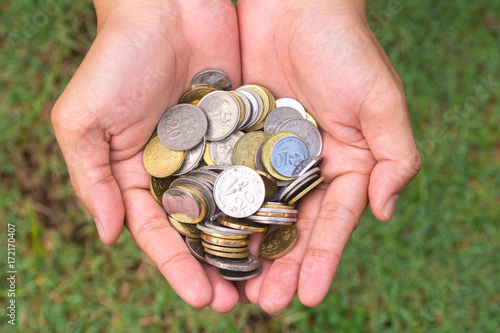 Close up coins in hand