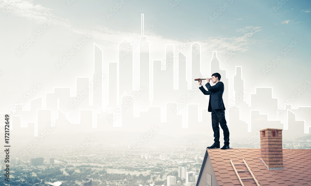 Engineer man standing on roof and looking in spyglass. Mixed med Engineer man standing on roof and looking in spyglass. Mixed med