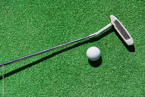 Mini-golf ball on artificial grass. Summertime.