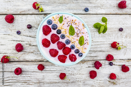 A bowl of healthy and delicious smoothie with grains and fresh berry fruit. 