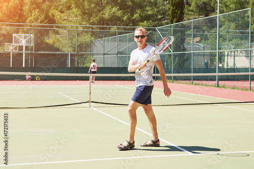 Man playing tennis. © standret