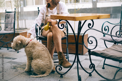 Woman in cafe bar with dog