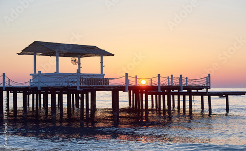 Wooden pier on a fancy orange sunset. © standret