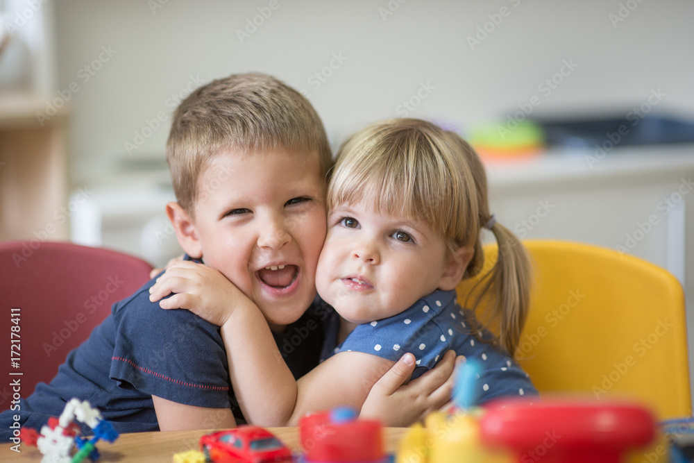 Blonde brother and sister is hugging Blonde brother and sister is hugging