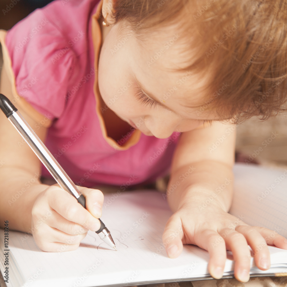 Little beautiful child girl writing a letter. (Education, studies, success, happy childhood concept) Little beautiful child girl writing a letter. (Education, studies, success, happy childhood concept)