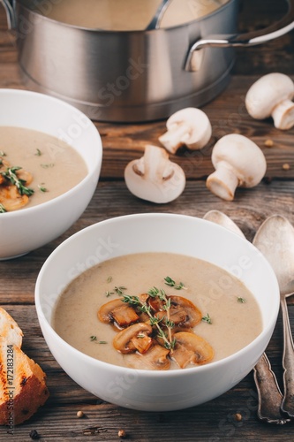 Cream soup puree with mushroom on wooden background