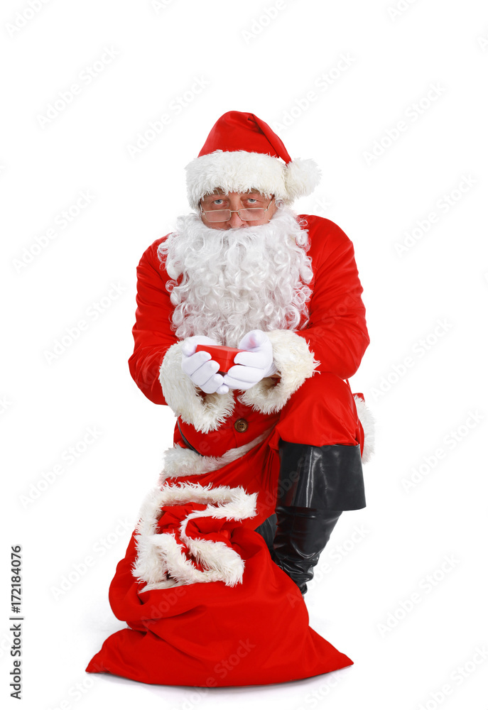 Real Santa Claus carrying big bag full of gifts, isolated on white background Real Santa Claus carrying big bag full of gifts, isolated on white background