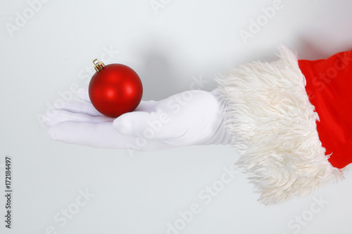 Happy Santa Claus looking out from behind the blank sign isolated on white background