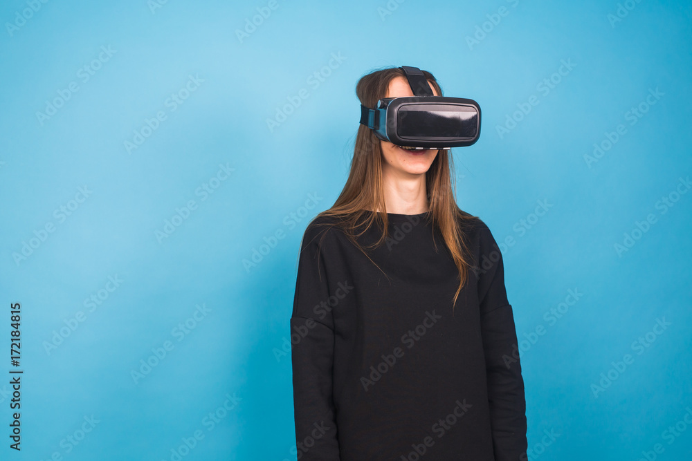 Young woman wearing virtual reality device. Technology, virtual reality and people concept