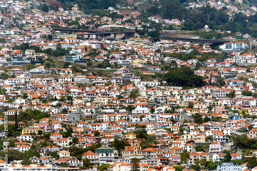 houses on the steep slopes of the city of Funchal, capital of the Portuguese island of Madeira © villorejo